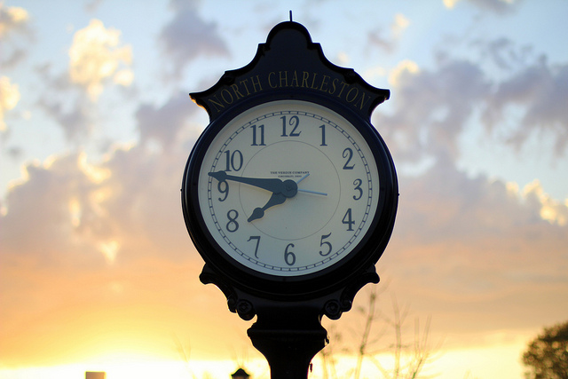 an outdoor clock at sunset